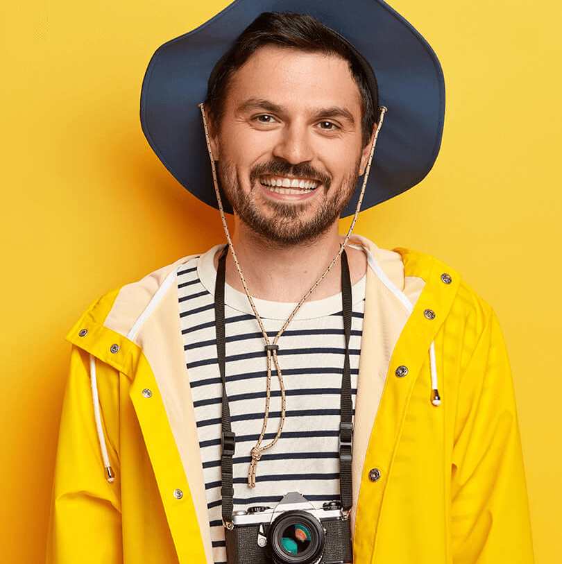 cheerful-active-young-male-traveler-smiles-broadly-enjoys-spare-time-favourite-hobby-makes-pics-with-retro-camera-dressed-casual-raincoat-hat-enjoys Team image 1
